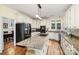 Bright kitchen with white cabinets, granite countertops, stainless steel appliances, and an island at 4716 Heatherton Pl, Charlotte, NC 28270