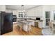 Spacious kitchen with granite island, white cabinets, and breakfast bar area at 4716 Heatherton Pl, Charlotte, NC 28270