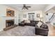 Comfortable living room with brick fireplace and a large sectional sofa at 4716 Heatherton Pl, Charlotte, NC 28270