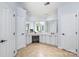 Large main bathroom with a fireplace, multiple mirrors, and cabinet space at 4716 Heatherton Pl, Charlotte, NC 28270