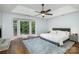 Main bedroom featuring tray ceiling, fireplace, bay window with wooded views at 4716 Heatherton Pl, Charlotte, NC 28270