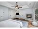 Spacious main bedroom with a ceiling fan, fireplace, and hard wood floors at 4716 Heatherton Pl, Charlotte, NC 28270