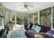 Sun room with a ceiling fan, couch, and view of the back yard at 4716 Heatherton Pl, Charlotte, NC 28270