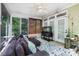 Bright sunroom with a comfortable couch, fish tank, and plenty of natural light at 4716 Heatherton Pl, Charlotte, NC 28270