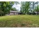 Expansive backyard with lush green lawn, partially fenced with a screened-in back porch at 5233 Great Wagon Rd, Charlotte, NC 28215