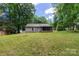 Spacious backyard features a well-maintained lawn and a screened-in porch at 5233 Great Wagon Rd, Charlotte, NC 28215