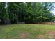 Wide backyard features a storage shed and wooden deck, enclosed by wood fence at 5233 Great Wagon Rd, Charlotte, NC 28215