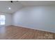 Spacious bedroom featuring vaulted ceilings and new wood-look flooring at 5233 Great Wagon Rd, Charlotte, NC 28215
