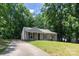 Charming single-story home with a well-manicured lawn and mature trees at 5233 Great Wagon Rd, Charlotte, NC 28215