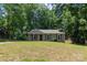 Charming single-story home with a well-maintained lawn and a backdrop of mature trees at 5233 Great Wagon Rd, Charlotte, NC 28215