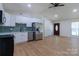 Bright, updated kitchen featuring modern appliances, white cabinets, and wood-look flooring at 5233 Great Wagon Rd, Charlotte, NC 28215