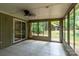 A sunroom with tile flooring, ceiling fan, and yard access at 5233 Great Wagon Rd, Charlotte, NC 28215