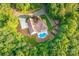 Aerial view of the property showcasing the home, pool, and lush landscaping, offering privacy and serenity at 560 Blue Sky Dr, Dallas, NC 28034
