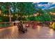 Spacious wooden deck with outdoor seating, fire pit, grill, and string lights, ideal for entertaining at 560 Blue Sky Dr, Dallas, NC 28034