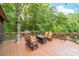 Spacious back deck features a gas fire pit, grill, and comfortable seating for outdoor relaxation and entertaining at 560 Blue Sky Dr, Dallas, NC 28034