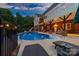 Spacious backyard with in-ground pool, slide, lounge chairs, and covered patio, perfect for outdoor enjoyment at 560 Blue Sky Dr, Dallas, NC 28034