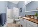 Cozy bathroom featuring a white vanity with a brown countertop and tiled backsplash at 560 Blue Sky Dr, Dallas, NC 28034