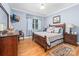 Comfortable bedroom featuring a beautiful wood bed frame and light blue walls at 560 Blue Sky Dr, Dallas, NC 28034