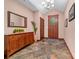 Inviting foyer boasts tile flooring, stained glass door, a wooden buffet, and a coat closet for a warm welcome at 560 Blue Sky Dr, Dallas, NC 28034
