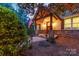 Inviting front porch with stone accents, American flag, and warm lighting, perfect for relaxing outdoors at 560 Blue Sky Dr, Dallas, NC 28034