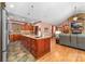 Large kitchen with a central island, stone countertops, hardwood floors, stainless steel appliances, and open concept design at 560 Blue Sky Dr, Dallas, NC 28034