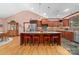 Spacious kitchen with large central island, granite countertops, wooden cabinetry, and stainless steel appliances at 560 Blue Sky Dr, Dallas, NC 28034