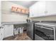 Well-organized laundry room with modern washer and dryer, cabinetry, and shelving at 560 Blue Sky Dr, Dallas, NC 28034