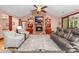 Warm living room features a stone fireplace, built-in shelving, hardwood floors, and comfortable seating at 560 Blue Sky Dr, Dallas, NC 28034