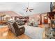 Open-concept living room boasts hardwood floors, stone fireplace, comfortable seating, and seamless transition to other spaces at 560 Blue Sky Dr, Dallas, NC 28034