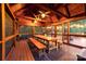 Cozy screened porch with wooden table and benches, offering a relaxing outdoor dining space at 560 Blue Sky Dr, Dallas, NC 28034