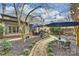 Inviting backyard with brick patio, stone pathway, manicured landscaping, and outdoor furniture at 5721 Ballinard Ln, Charlotte, NC 28277