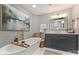 Spa-like bathroom with a soaking tub, vanity, and elegant decor and a large painting at 5721 Ballinard Ln, Charlotte, NC 28277