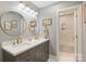 Elegant bathroom with double sinks, modern fixtures, a large mirror, and a doorway leading to the bathtub at 5721 Ballinard Ln, Charlotte, NC 28277