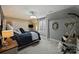 Comfortable bedroom featuring a cozy bed, neutral decor, natural light, and a hanging chair for relaxation at 5721 Ballinard Ln, Charlotte, NC 28277