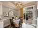Charming dining area with a view of the backyard, modern lighting, and lemon-themed decor at 5721 Ballinard Ln, Charlotte, NC 28277