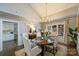 Cozy dining room featuring hardwood floors, chandelier, and access to the kitchen at 5721 Ballinard Ln, Charlotte, NC 28277