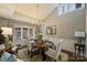 Bright dining room featuring a vaulted ceiling, chandelier, and a large window overlooking the backyard at 5721 Ballinard Ln, Charlotte, NC 28277