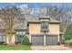 Charming two-story home with gray roof, manicured landscape, and attached two-car garage at 5721 Ballinard Ln, Charlotte, NC 28277