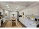 Bright, updated kitchen with white cabinets, a center island with seating, and stainless steel appliances at 5721 Ballinard Ln, Charlotte, NC 28277