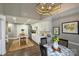 Bright kitchen featuring white cabinetry, marble countertops, and a stylish island table with seating at 5721 Ballinard Ln, Charlotte, NC 28277