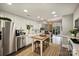 Updated kitchen features stainless steel appliances, white cabinets, breakfast area, and backyard access at 5721 Ballinard Ln, Charlotte, NC 28277