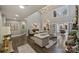 Elegant living room with high ceilings, hardwood floors, and neutral-toned furniture at 5721 Ballinard Ln, Charlotte, NC 28277