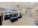 Inviting living room with a large navy sofa, ottoman, and a ceiling fan, creating a cozy and stylish space at 5721 Ballinard Ln, Charlotte, NC 28277