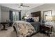 Cozy primary bedroom featuring a large bed, elegant decor, ample natural light, and stylish bedside tables at 5721 Ballinard Ln, Charlotte, NC 28277