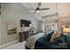 Stylish main bedroom with vaulted ceiling, large windows, wooden dresser, and cozy decor at 5721 Ballinard Ln, Charlotte, NC 28277