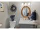 Stylish powder room featuring elegant vanity with gold hardware and an decorative framed mirror at 5721 Ballinard Ln, Charlotte, NC 28277
