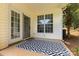 Inviting back patio featuring a geometric patterned rug and double doors to the interior at 6204 Half Dome Dr, Charlotte, NC 28269