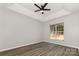 Bright bedroom features a modern ceiling fan, ample natural light from the window, and beautiful hardwood floors at 6204 Half Dome Dr, Charlotte, NC 28269