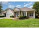 Lovely home featuring a well-maintained lawn, two-car garage and beautiful front yard landscaping at 6204 Half Dome Dr, Charlotte, NC 28269