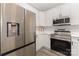 Modern kitchen featuring stainless steel appliances, quartz countertops and sleek white cabinetry at 6204 Half Dome Dr, Charlotte, NC 28269